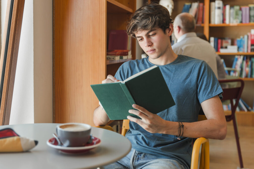 concentrated-man-enjoying-reading-book